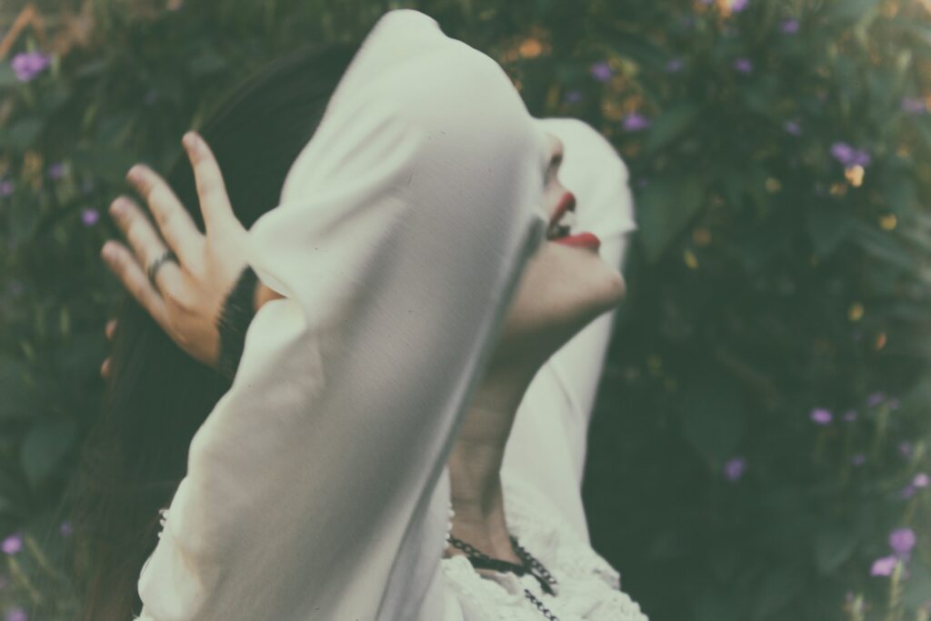 woman holding her hair near on trees